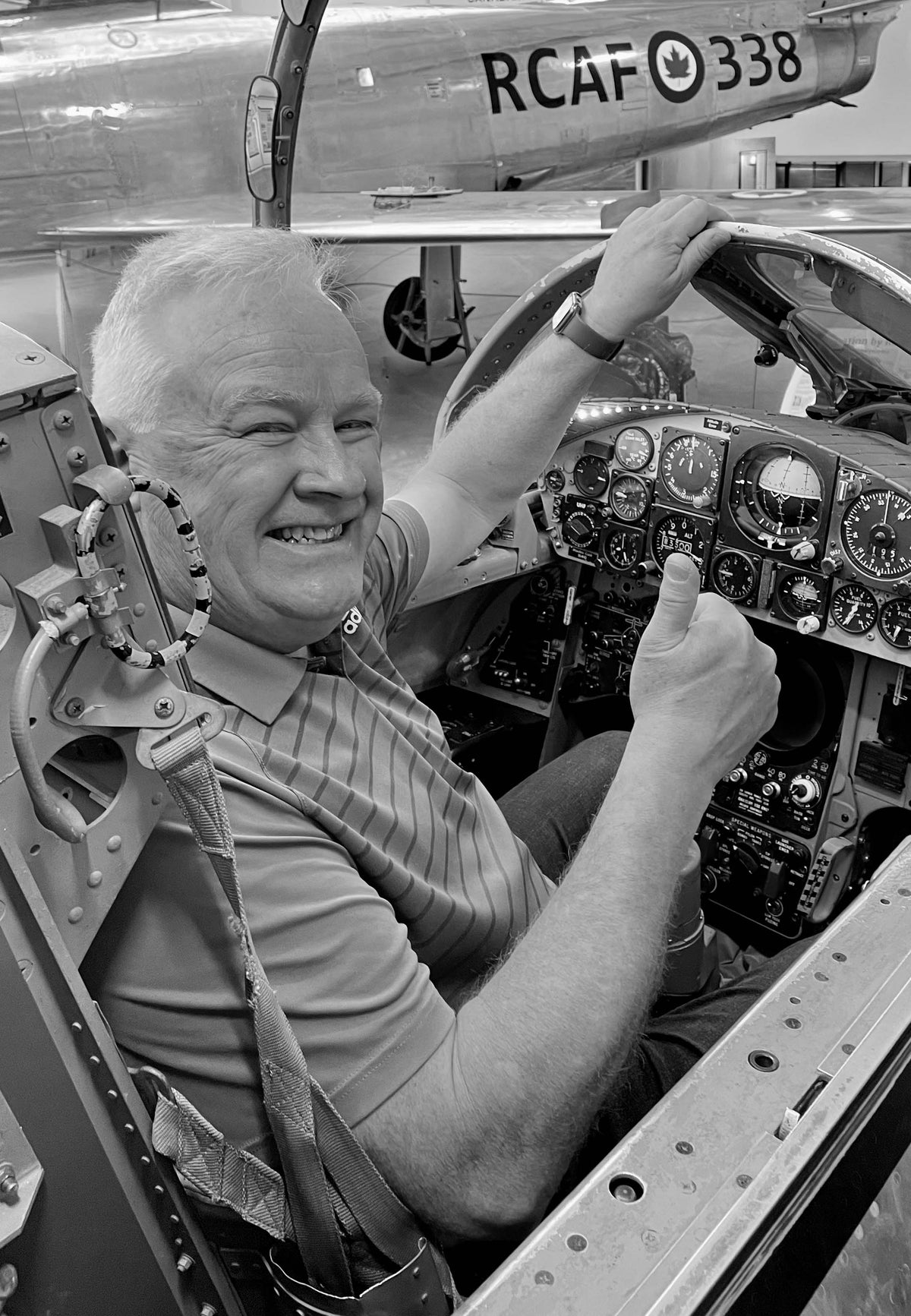 black and white portrait of the author, D.M. Pruden, sitting in the cockpit of an RCAF fighter jet.